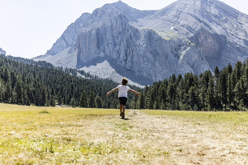 child running toward a mountain