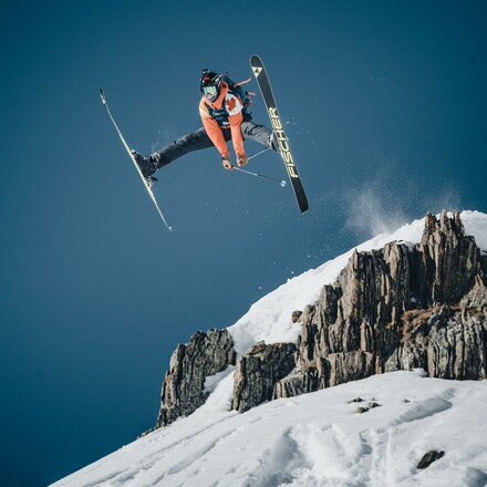 Freeride skier jumping off mountain