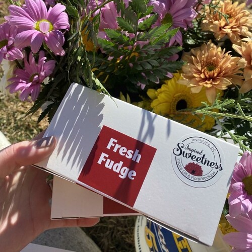 Flowers and chocolate flowers held by a hand