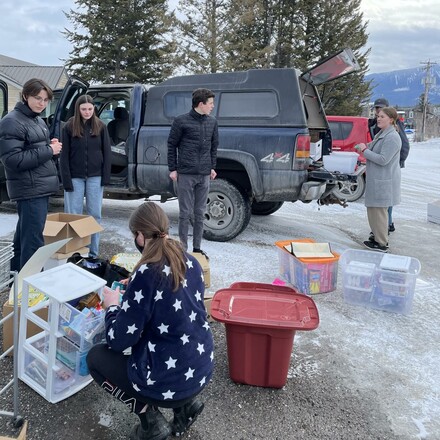 Students packing supplies into a truck