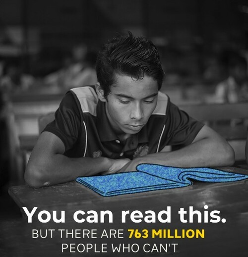 A black and white photo with a young man looking at a book. Caption says "You can read this but there are 763 million people who can't"